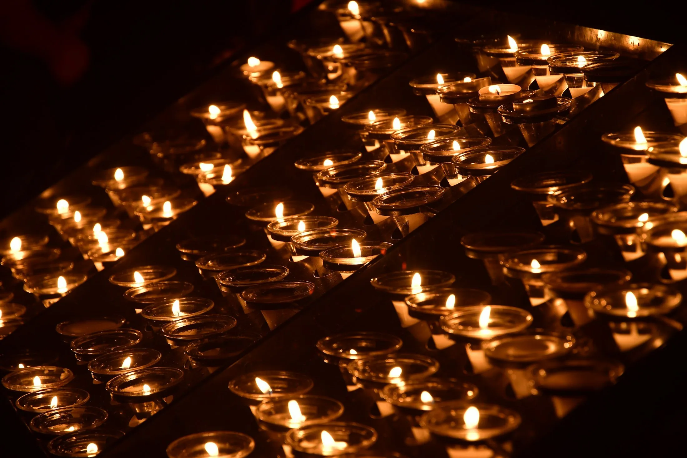 Lit remembrance candles in the dark